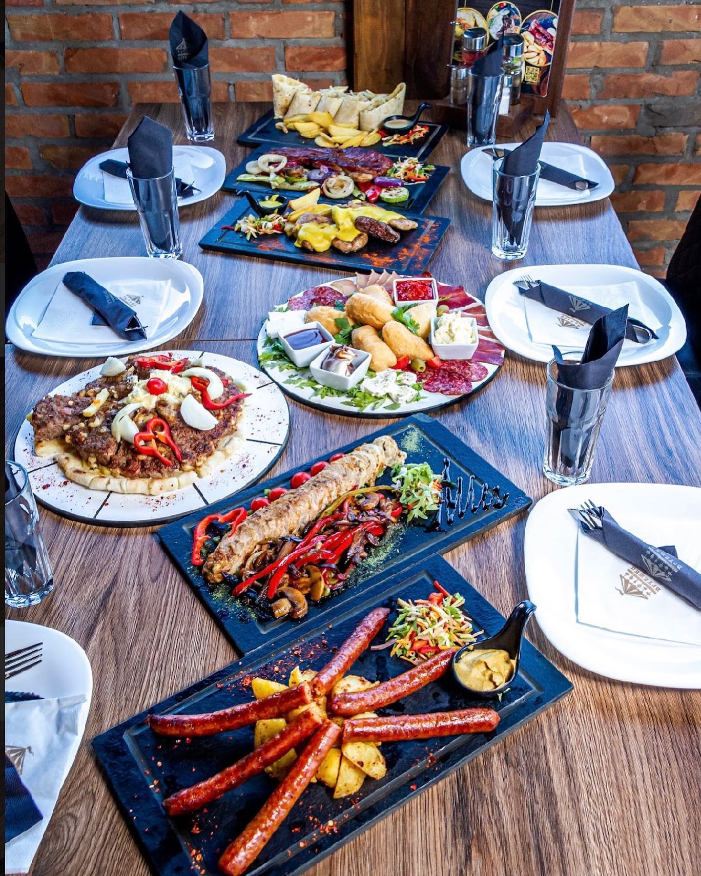 A table laden with delicious Serbian dishes at Vrteska Restoran